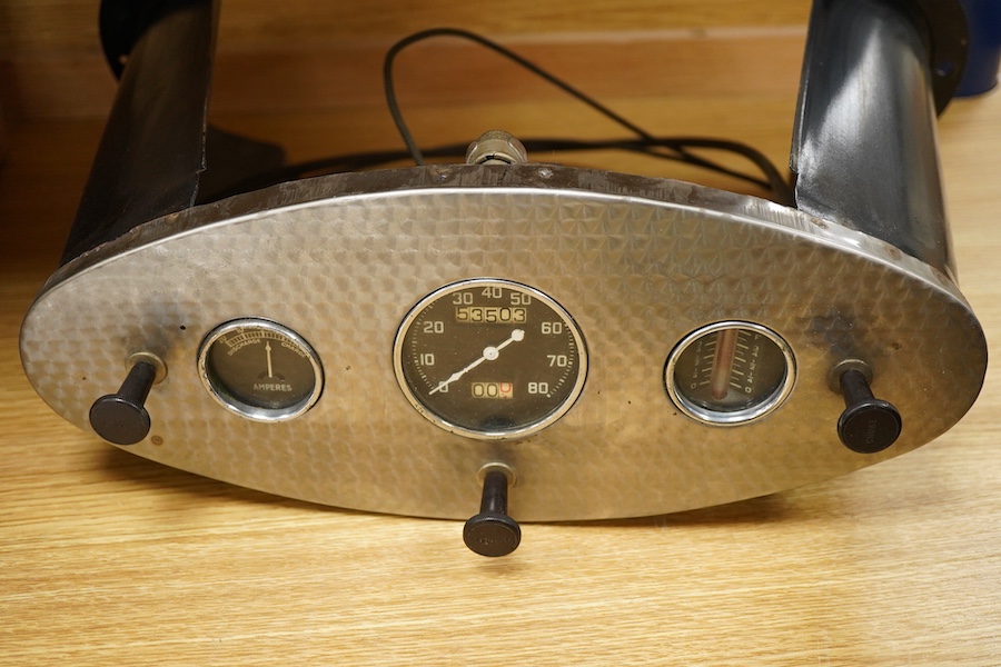Two Automobilia related items; a dashboard panel for a 1932 Ford roadster together with an early French dashboard clock